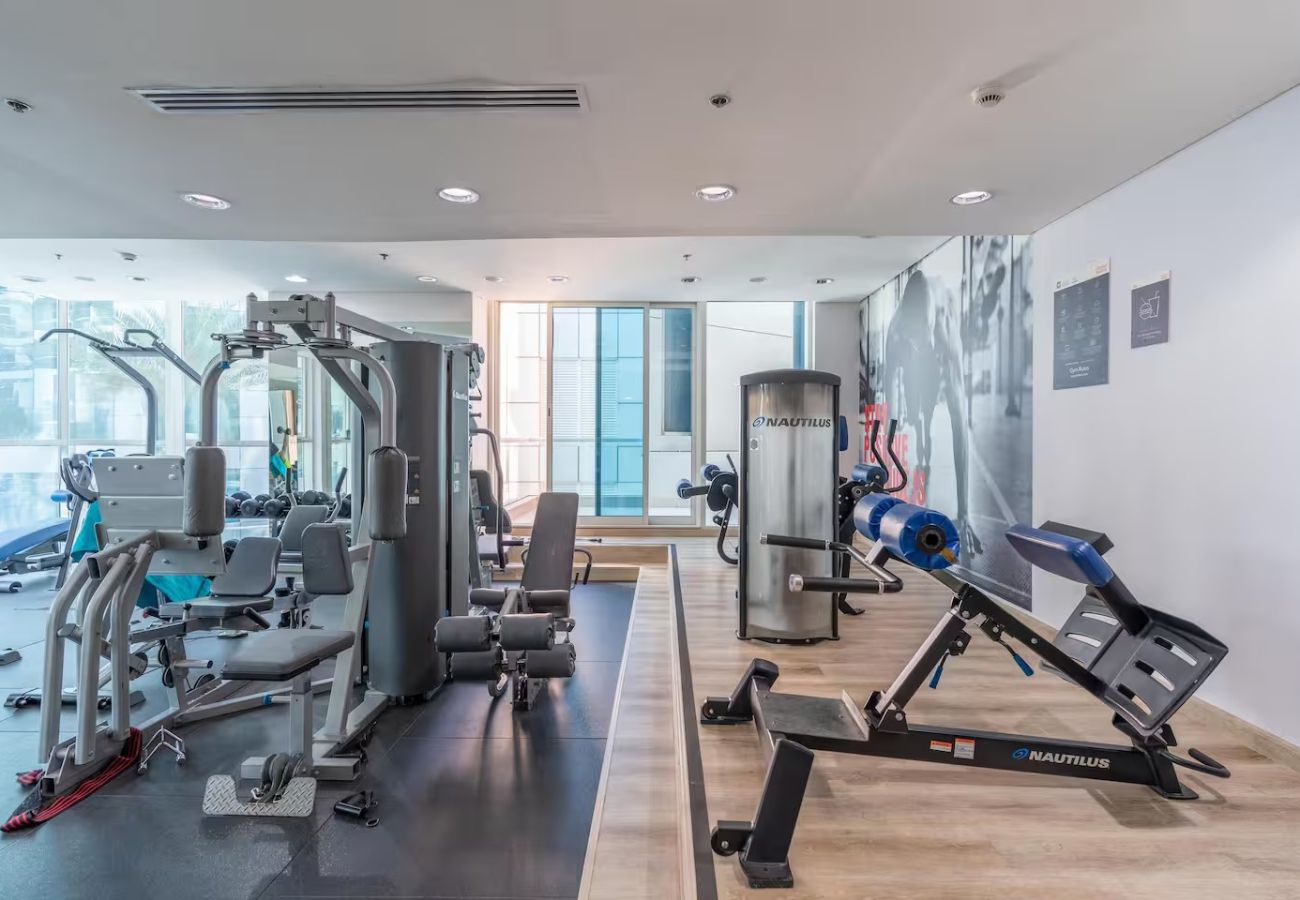 Apartment in Dubai - Stylish 1BR Apartment with Partial Sea View 