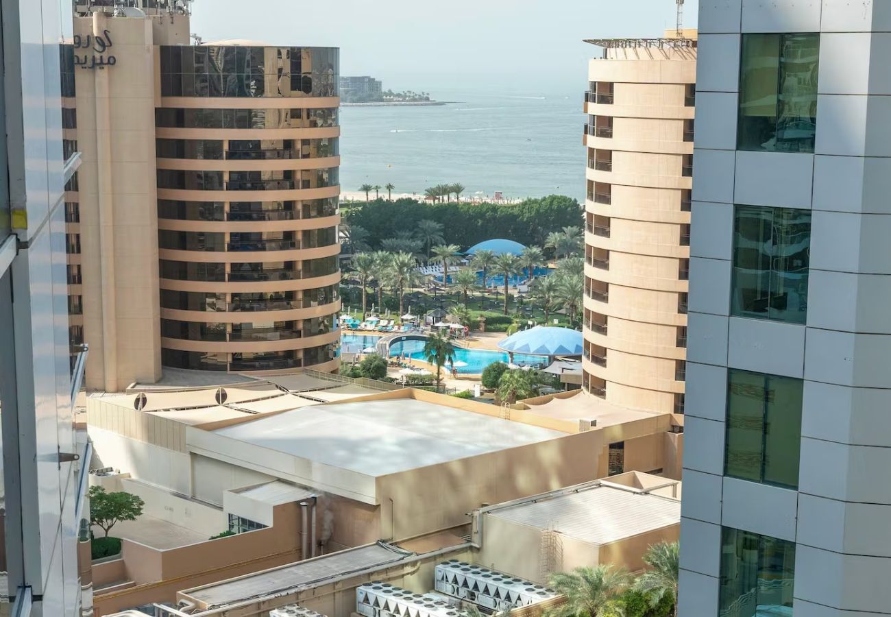 Apartment in Dubai - Stylish 1BR Apartment with Partial Sea View 